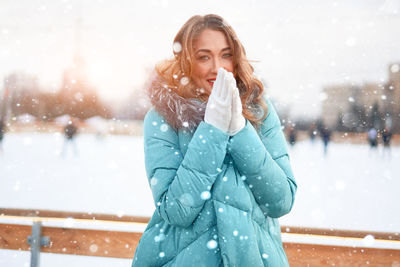 Portrait of smiling young woman standing outdoors