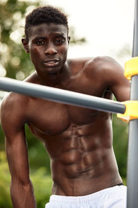 Portrait of young man exercising in gym