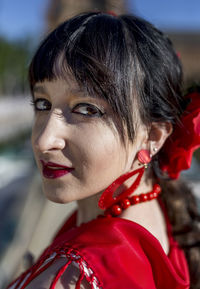 Close-up portrait of young woman in traditional clothes outdoors