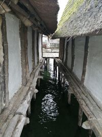 View of pier over canal amidst buildings