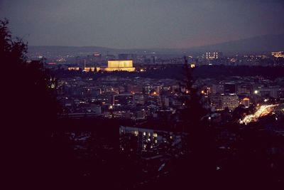 High angle view of illuminated buildings in city at night