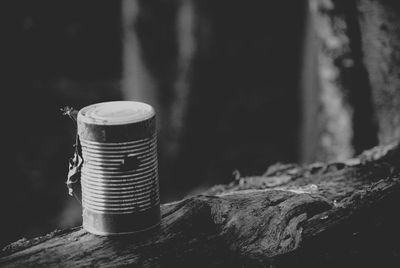 Close-up of metallic container on wood