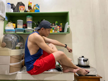Man sitting in kitchen at home