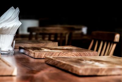 Close-up of wooden plates on table in restaurant