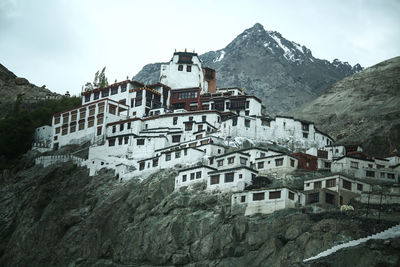 Houses on snowcapped mountains against sky