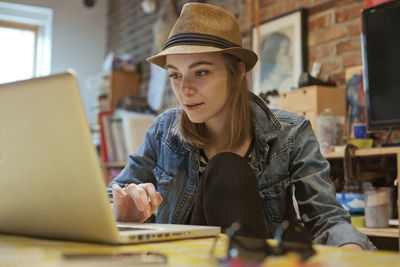 Portrait of a beautiful young woman on her laptop