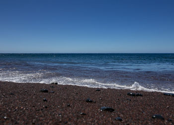 Scenic view of sea against clear blue sky