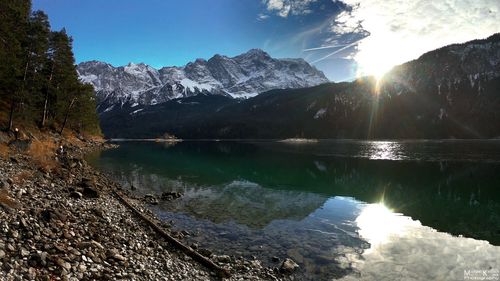 Scenic view of lake and mountains against sky