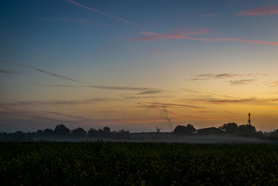 Scenic view of field against sky during sunset