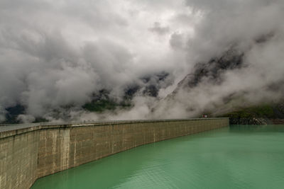 Grande dixence dam in the swiss alps, cloudy sky.