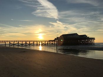 Scenic view of beach against sky during sunset