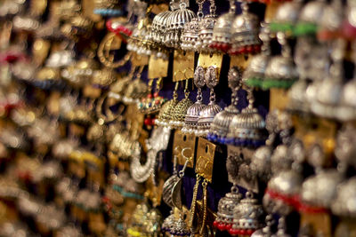 Close-up of decorations hanging in store for sale