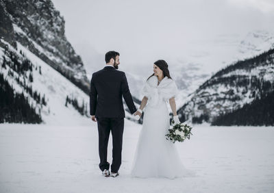 Rear view of couple walking on street