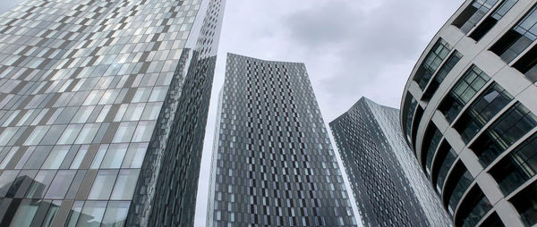 Low angle view of modern buildings against sky in city