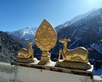 Statue of buddha against clear sky during winter