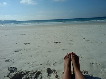 Low section of woman legs on beach