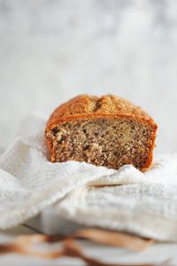 Close-up of bread on table against white background