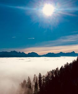 Scenic view of mountains against bright sun