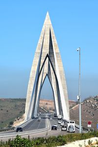 Bridge over road against clear sky