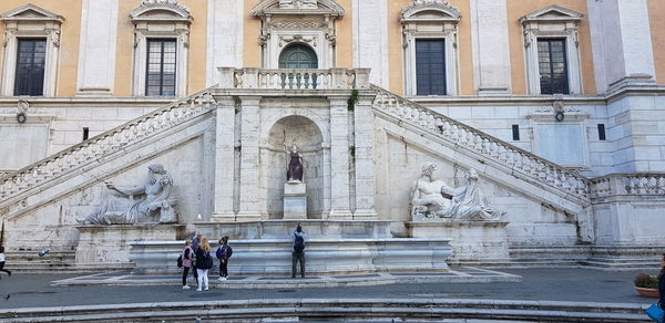 Statue in front of historical building