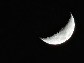 Low angle view of moon against sky at night