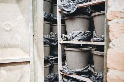 Clay pots on shelves in storage room