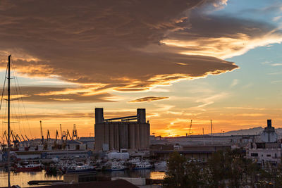 Buildings in city during sunset