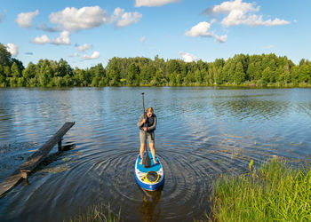 Rear view of man standing in lake