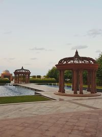 Gazebo by trees against sky