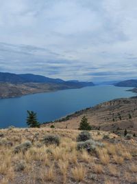 Scenic view of land and mountains against sky