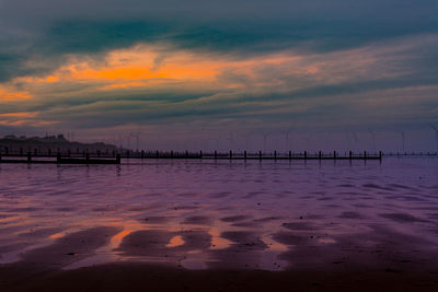 Scenic view of beach against sky during sunset