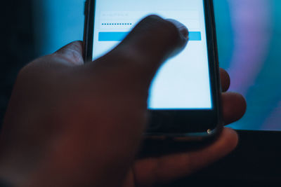 Close-up of hand using mobile phone. user typing password for sign in web 