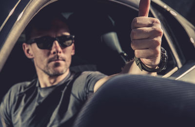 Man showing thumbs up from car