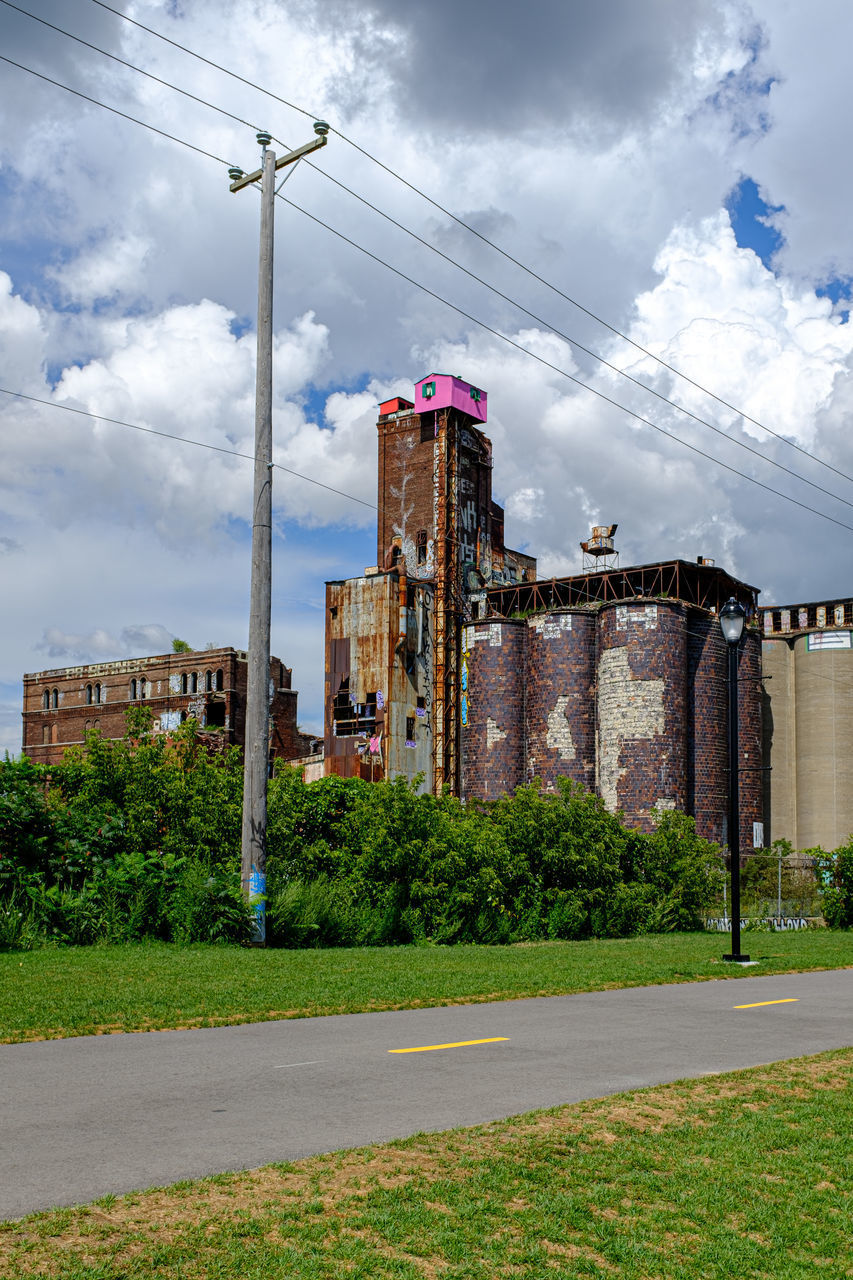 ROAD BY BUILDINGS AGAINST SKY