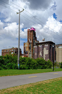 Street by buildings against sky