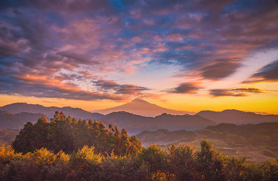 Scenic view of mountains against orange sky