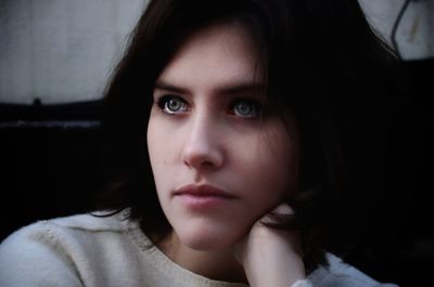 Close-up of thoughtful young woman looking away outdoors