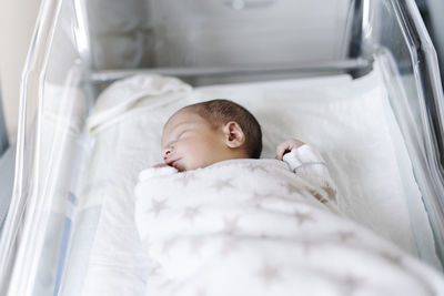 Sleeping baby lying in crib