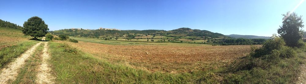 Panoramic view of landscape against clear blue sky