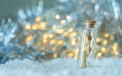 Close-up of snow on glass bottle