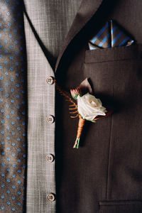 Midsection of bride holding bouquet