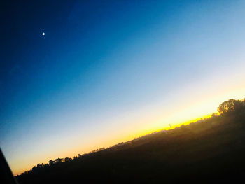 Scenic view of silhouette landscape against clear sky at sunset