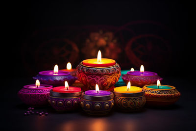 Close-up of illuminated candles on black background