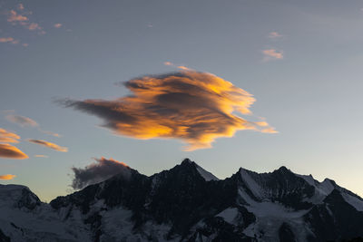 Low angle view of snowcapped mountains against sky during sunset