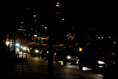 Cars on illuminated city at night