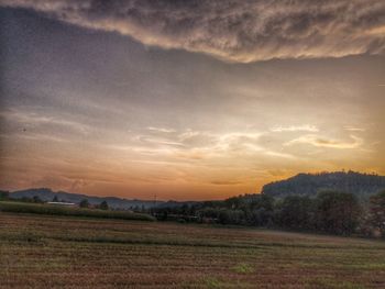 Scenic view of field against sky during sunset