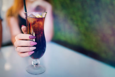 Close-up of hand holding glass of wine