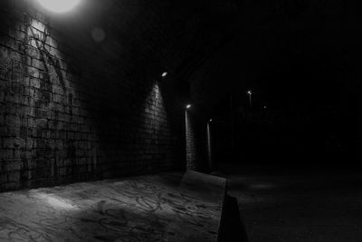 Illuminated tunnel at night