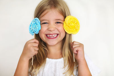 Portrait of a smiling girl holding face