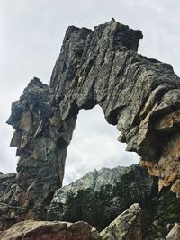 Low angle view of rock formation against sky